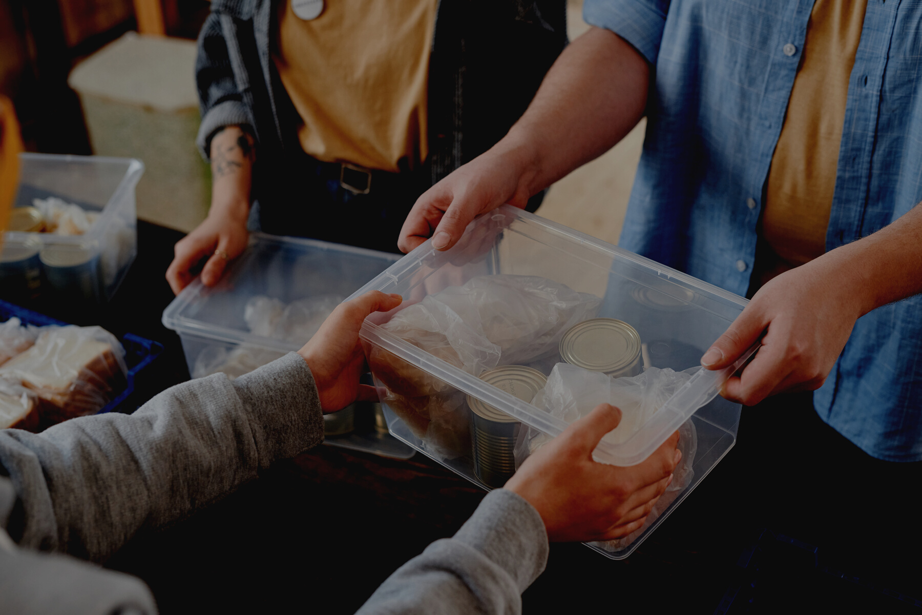 A Person Handing Over a Box with Food