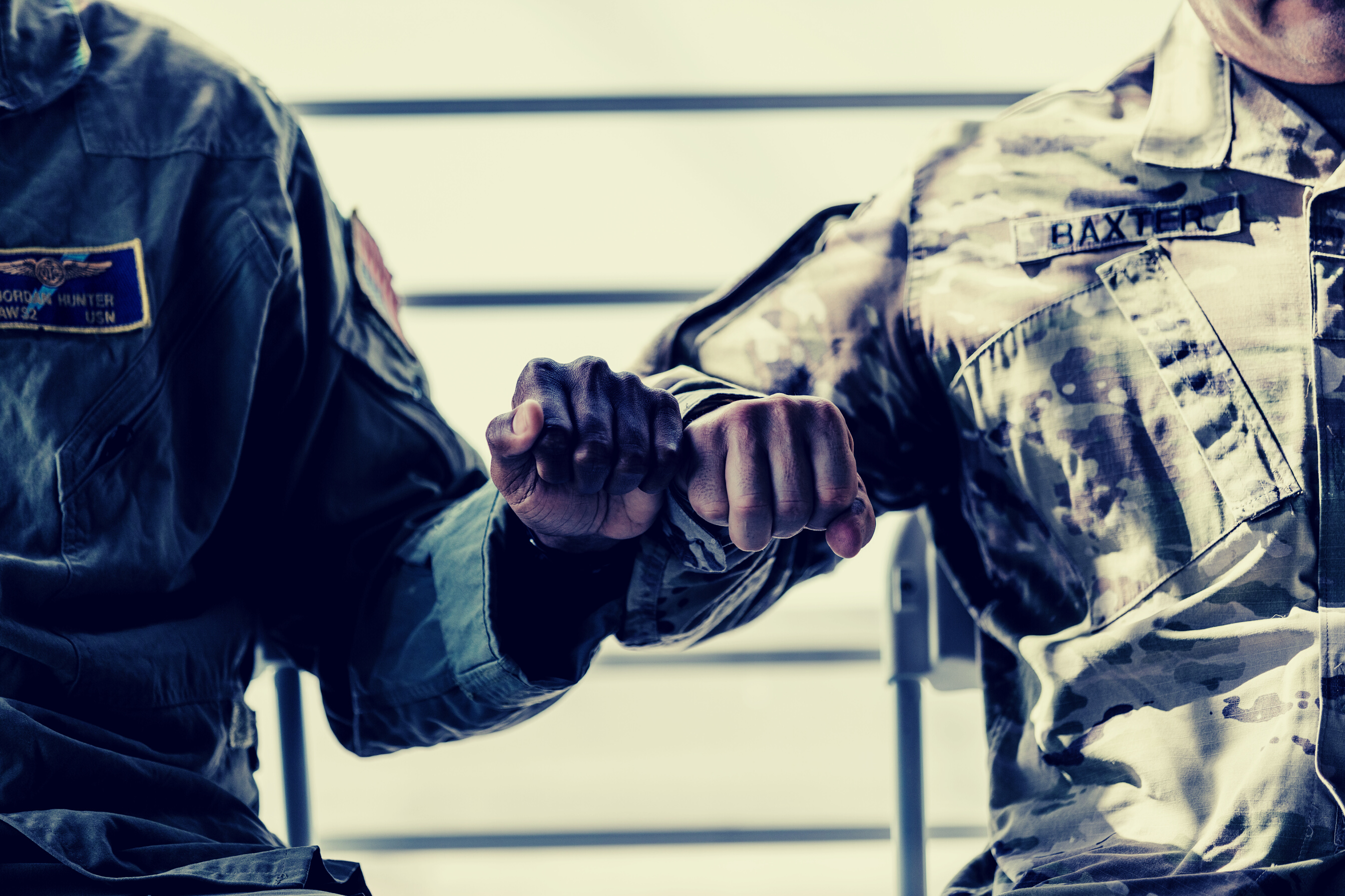 Close-Up Photo of Soldiers Doing a Fist Bump